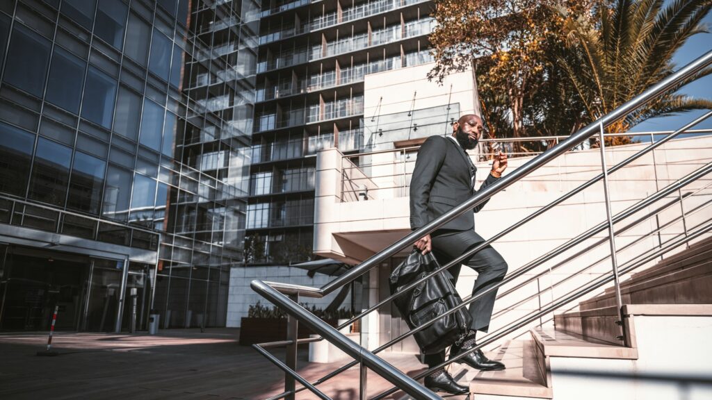 A black corporate man on the stairs